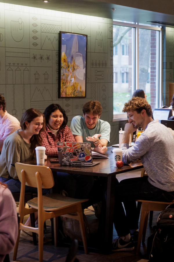 Group of friends chatting over coffee in Starbucks