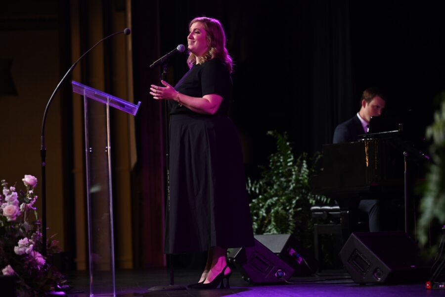 Amber Olney singing on stage.