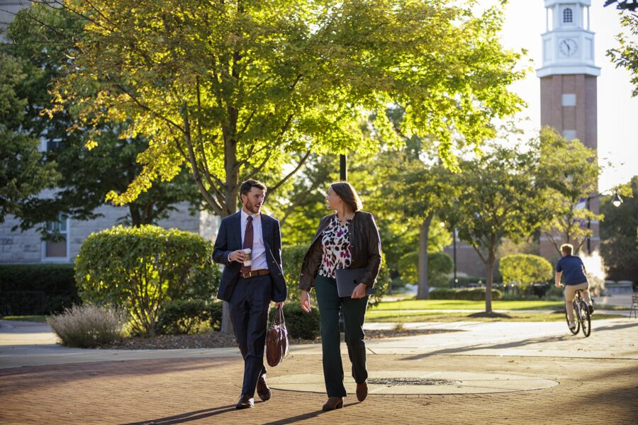 adults walking on campus